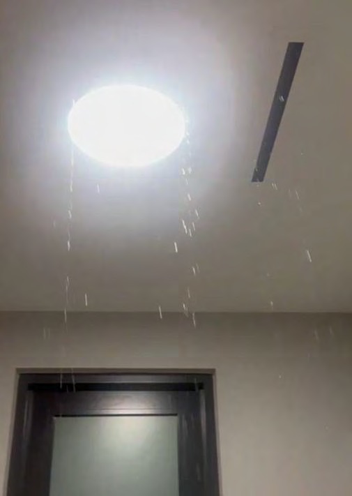 Water spouting from window frame — main staircase