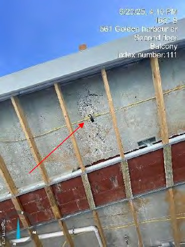 Crumbling concrete over exposed rusting rebar