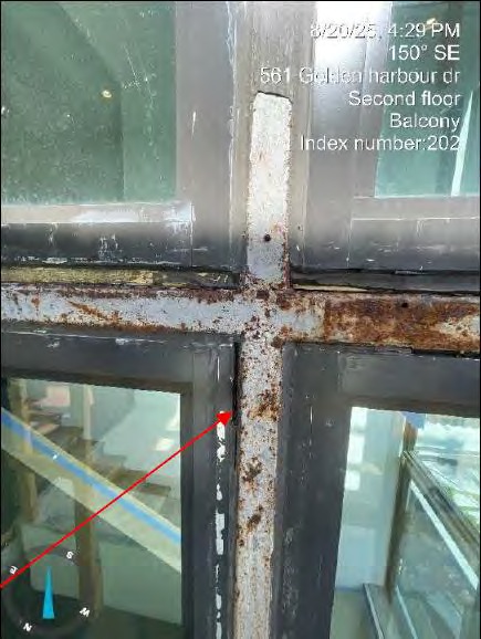 Corroded metal column and window mullion at main staircase