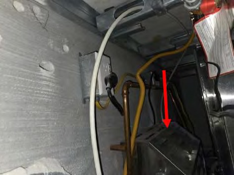 Unterminated, energized wiring left exposed above home's main entrance